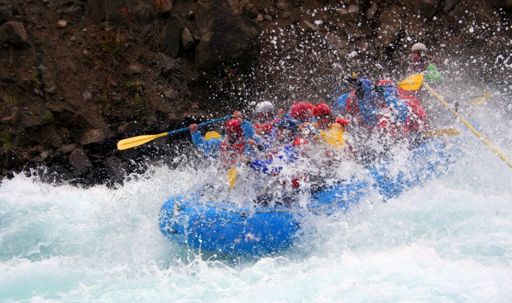 River Rafting a raft blasting through a wave